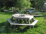 This hexagonal table, commissioned by Meikal and built by Ken, graces the back yard of the Hotel. A favorite place for meetings and informal, impromptu gatherings. A live curly willow is the table's centerpiece.
Photo by Ken Grunke